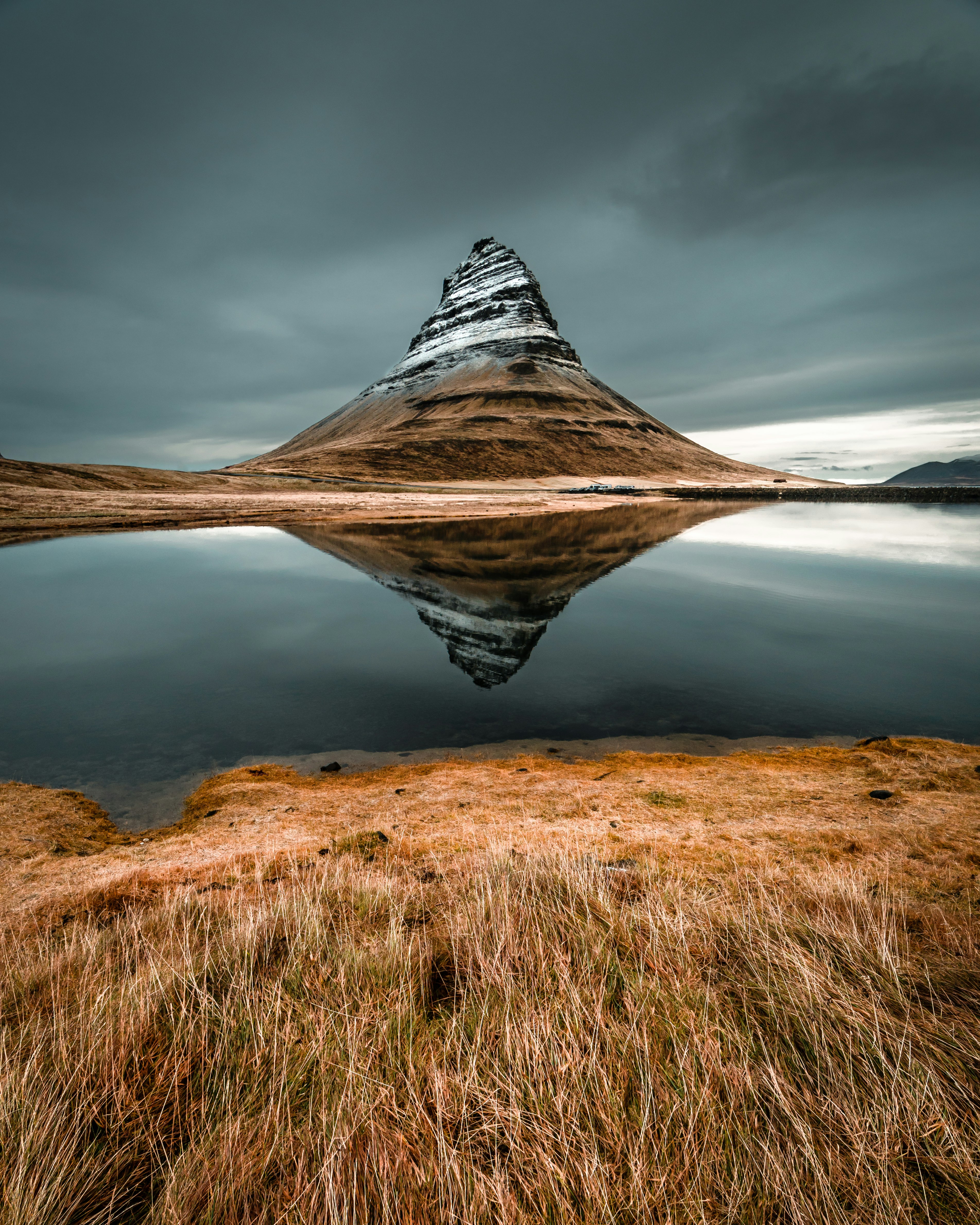 cone mountain with the distance of body of water